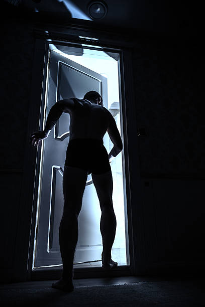 istock Young man enters open door from black room 597961746