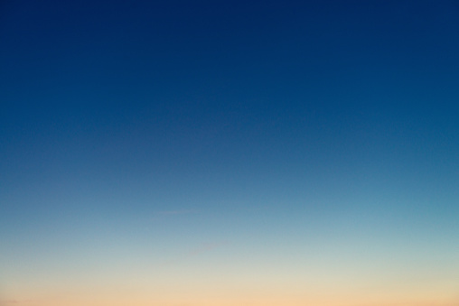 Genuine photograph of a graduated sky at dusk, with colours ranging from deep blue to pinky-orange.