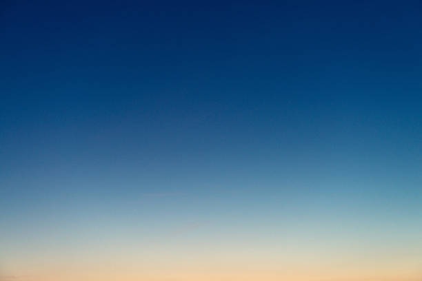 Graduated twilight horizon sky Genuine photograph of a graduated sky at dusk, with colours ranging from deep blue to pinky-orange. sky only stock pictures, royalty-free photos & images