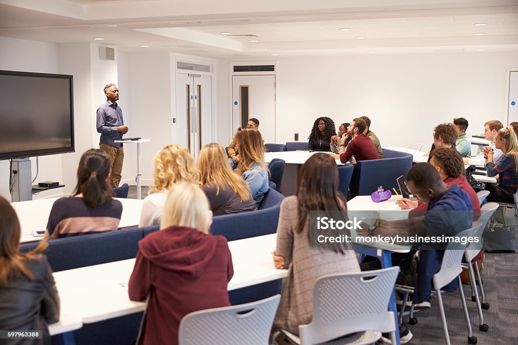 University students study in a classroom with male lecturer Lecture Hall Stock Photo