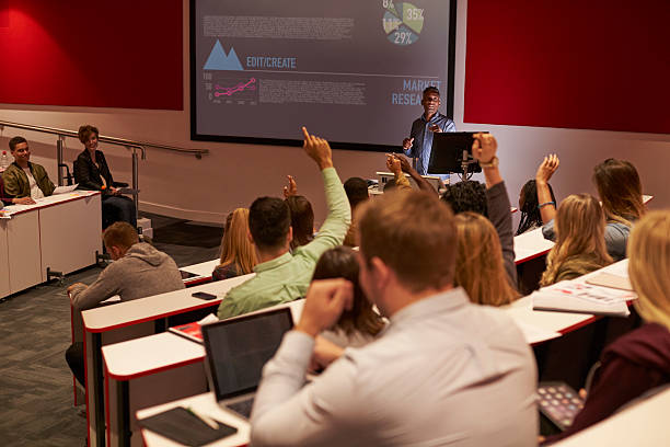 istock Students at university lecture raise hands to ask questions 597963406