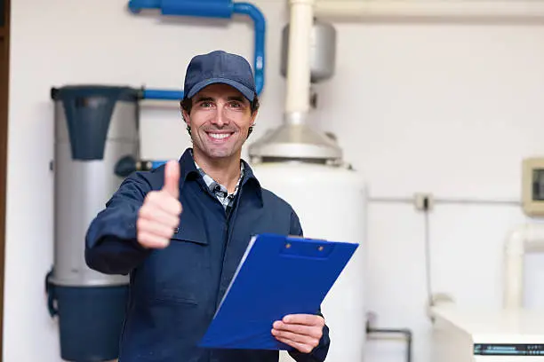 Smiling technician servicing a hot-water heater