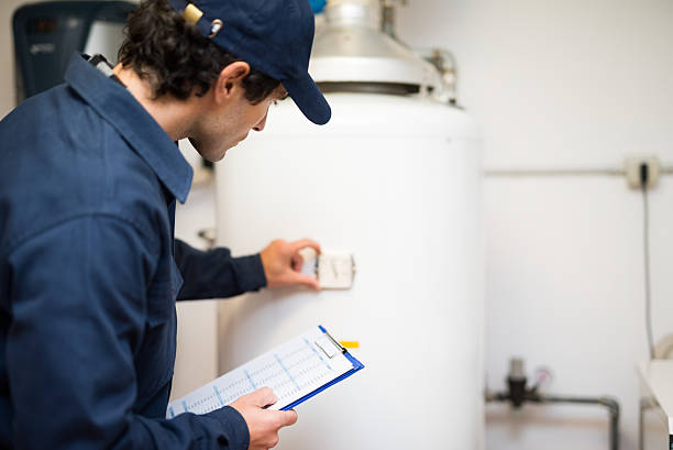 Plumber repairing an hot-water heater Plumber repairing an hot-water heater boiler photos stock pictures, royalty-free photos & images