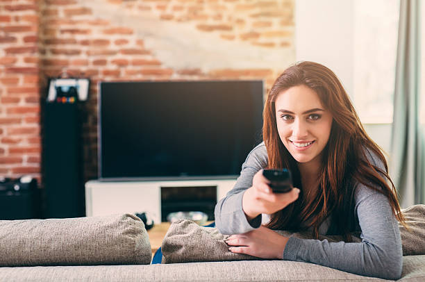 istock Woman watching TV 597967512