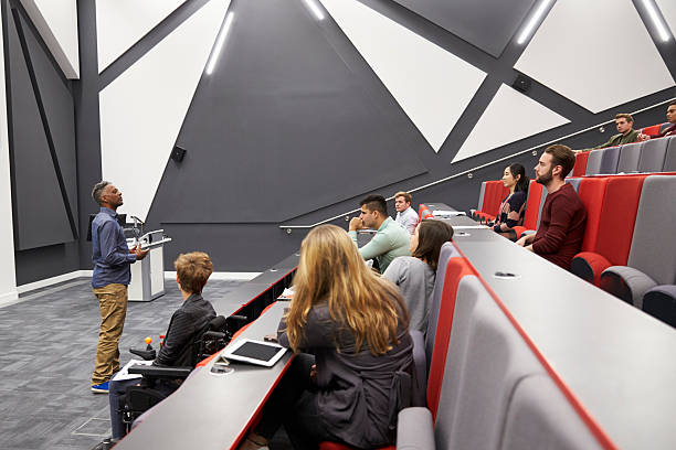istock Man lectures students in lecture theatre, front row seat POV 597967514