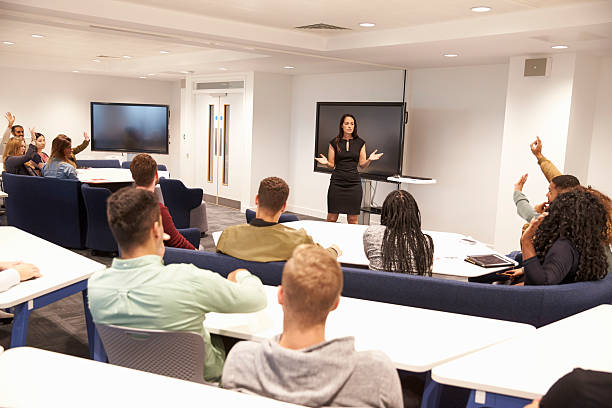 istock University students study in classroom with female lecturer 597967534