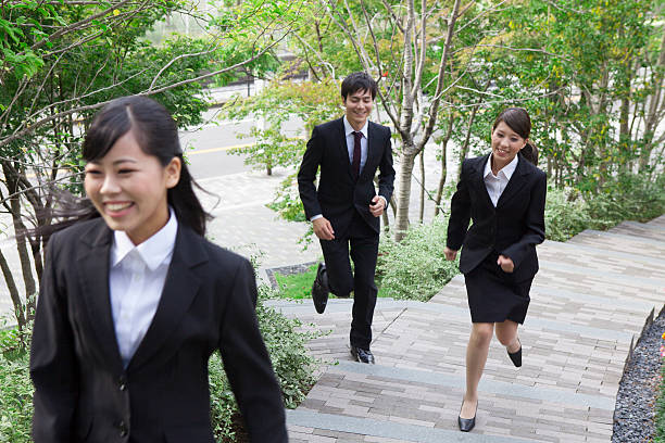 istock Japanese employees running up steps 597968926