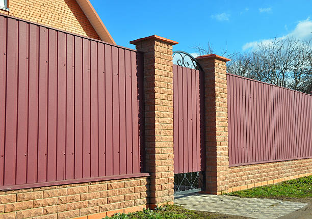 istock Red metal fence door 597969428