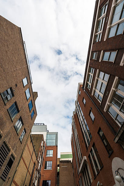 istock Low angle view of apartment building against sk 597969716