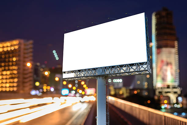 istock Blank billboard near expressway at night for advertisement. 597970178