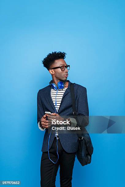 Afro American Guy In Fashionable Outfit Holding Smart Phone Stock Photo - Download Image Now