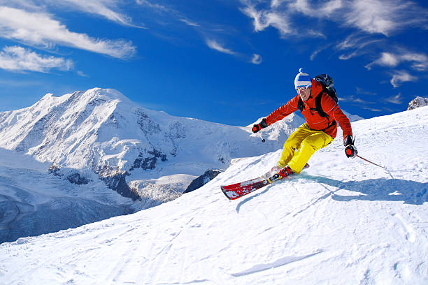 istock Skier skiing downhill against Matterhorn peak in Switzerland 597971890
