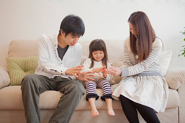 Japanese family sitting on sofa