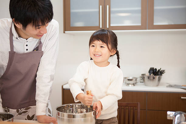 istock Japanese father and daughter cooking in the kitchen 598052906