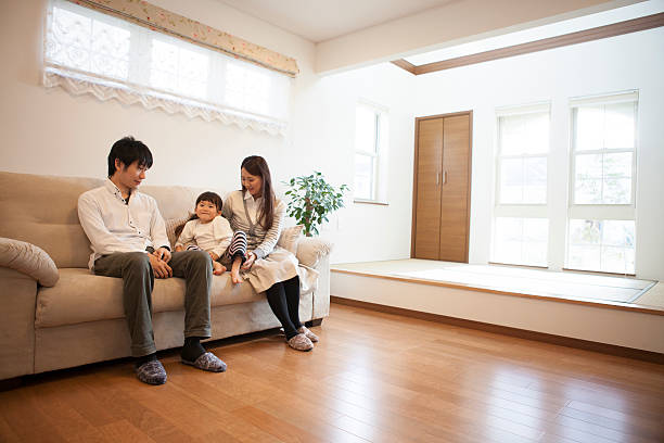 istock Japanese family sitting on sofa 598054876