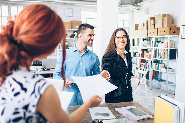 istock Young couple receiving documents in modern office 598055284