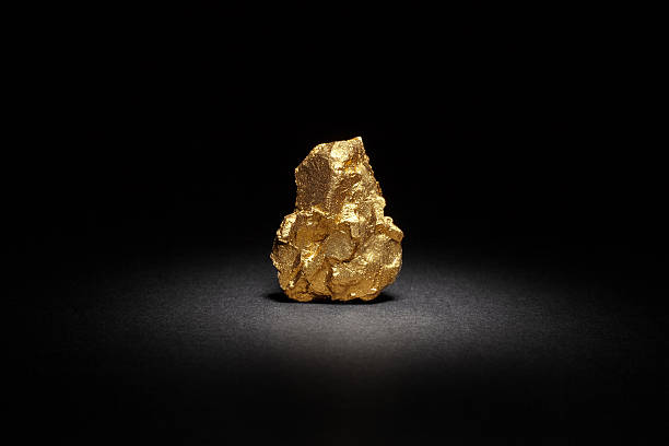 Closeup of big gold nugget Closeup of big gold nugget on a black background ounce stock pictures, royalty-free photos & images