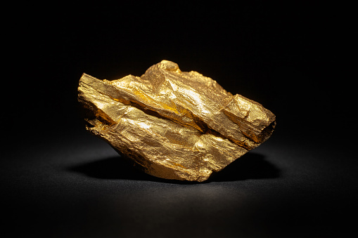 Closeup of big gold nugget on a black background