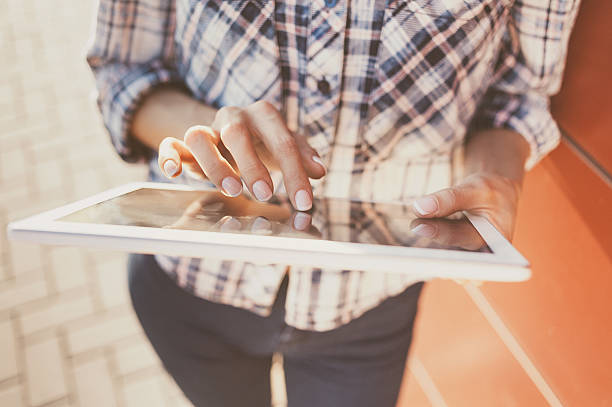 Girl using digital tablet outdoors