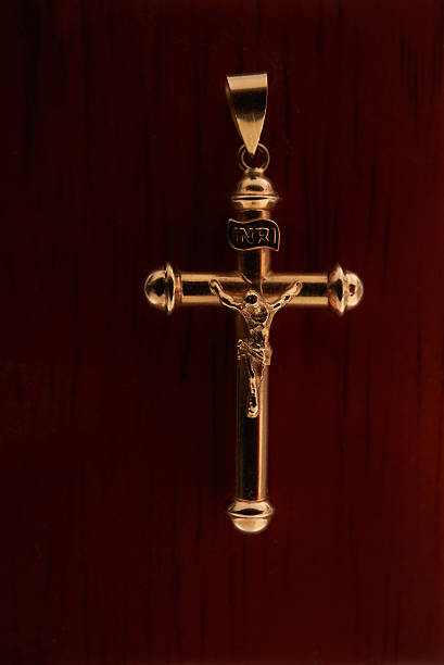 istock gold cross top on a wooden box up close 598056808