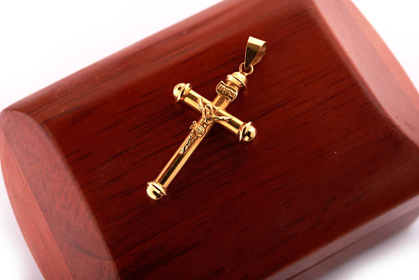 istock gold cross top on a wooden box on a diagonal 598056918