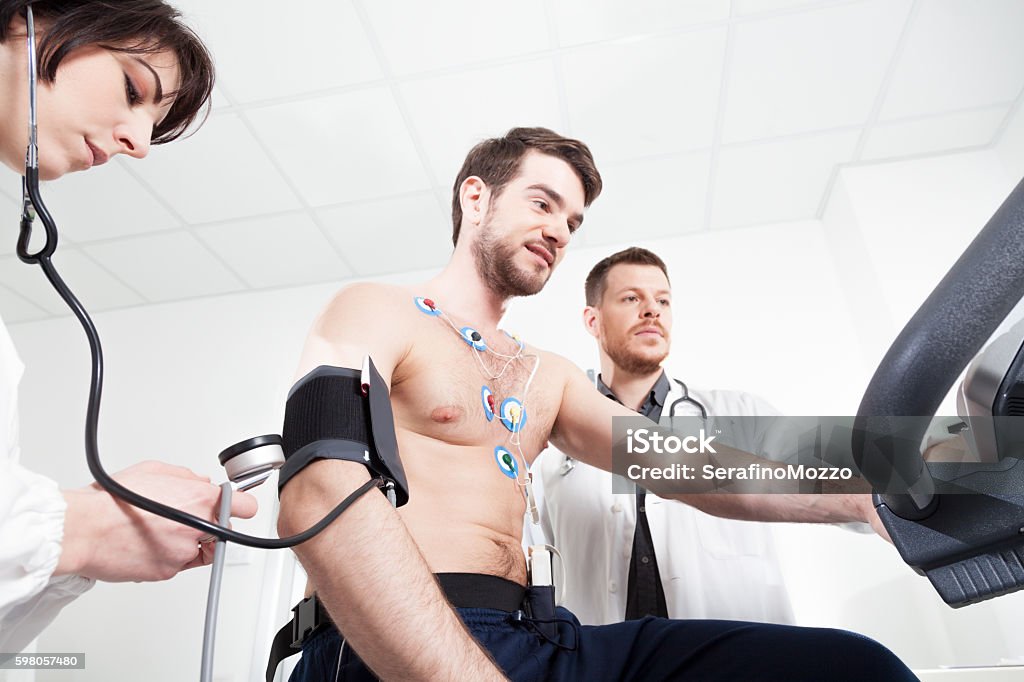 Heart diagnostic test with doctor Doctor and nurse assist the patient during the medical examination of cardiac stress test Electrocardiography Stock Photo
