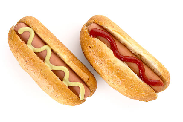 istock Hotdogs with mustard and ketchup isolated on white 598058240