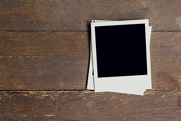 istock Vintage photo frame blank on old wood background with space 598060286