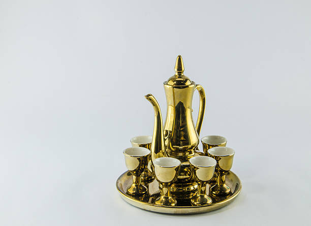 istock Gold jug Tea glass isolated white background . 598060418