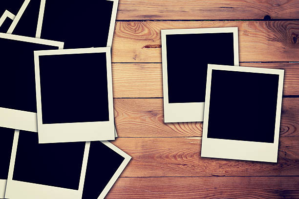 istock blank frame photo on wood background and texture with space 598060434