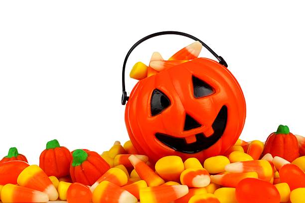 istock Halloween Jack-o-Lantern pail on a pile of candy over white 598060592