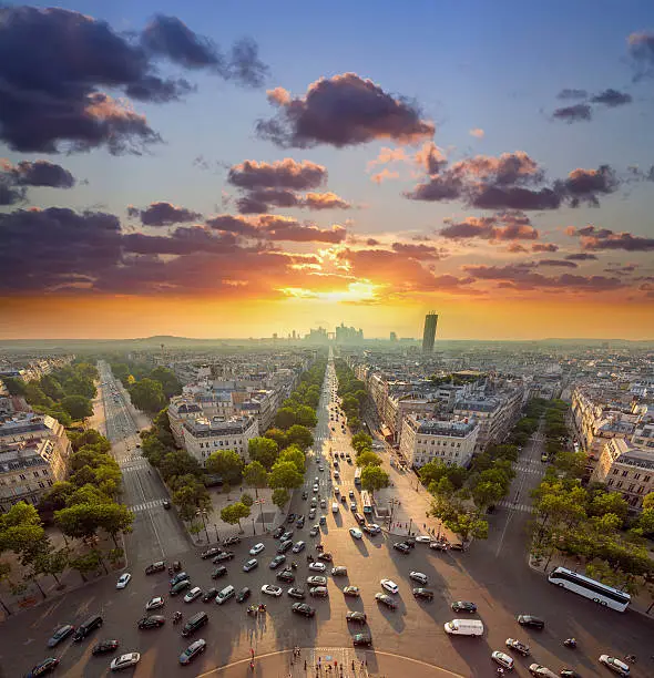 France Paris Champs Elysees with traffic at sunset looking from Arc de Triomphe towards La Defense