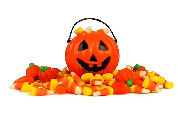istock Halloween Jack-o-Lantern pail with a pile of candy over white 598060676