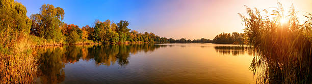 istock Lake sunset panorama in gold and blue 598060868