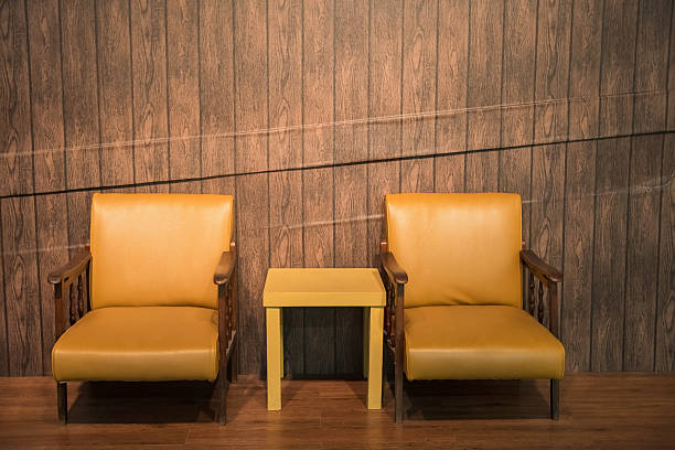 istock leather chair and table with wood wall 598061346