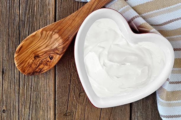 istock Greek yogurt in a heart shaped bowl, overhead scene 598062378