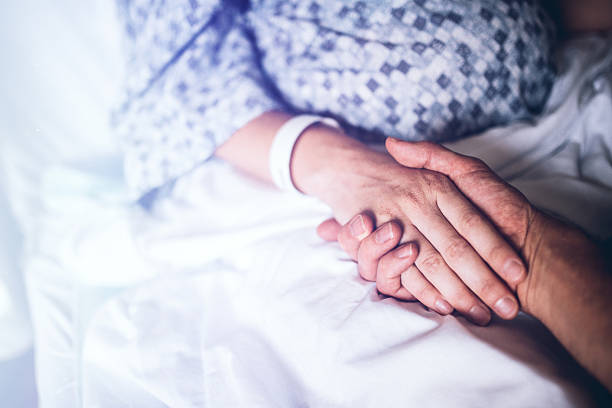 istock Holding Hands in Hospital Bed 598064818