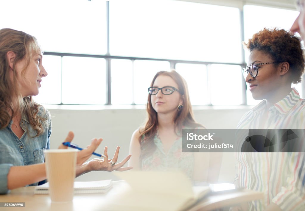 Unposed group of adult student in an open concept  class Candid picture of a university team working together.  Candid Stock Photo