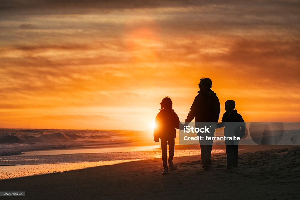 Family walk by the beach at sunset Family walk by the Hamptons Beach at sunset Family Stock Photo