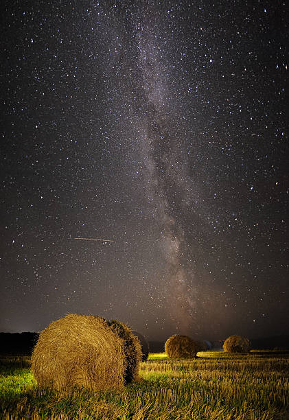 istock Milky Way and wheat field with haystacks 598073382