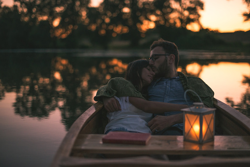 Couple in love enjoying an evening ride in a canoe.