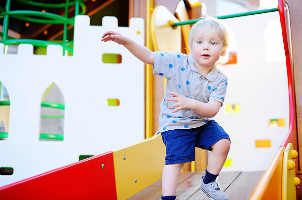 istock Toddler boy having fun on playground 598076880