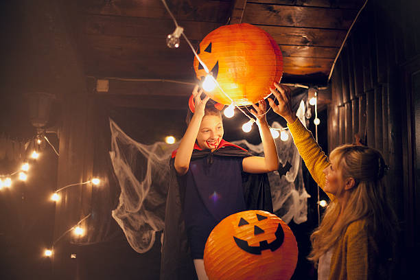 istock Mom and daughter decorate for Halloween 598077096
