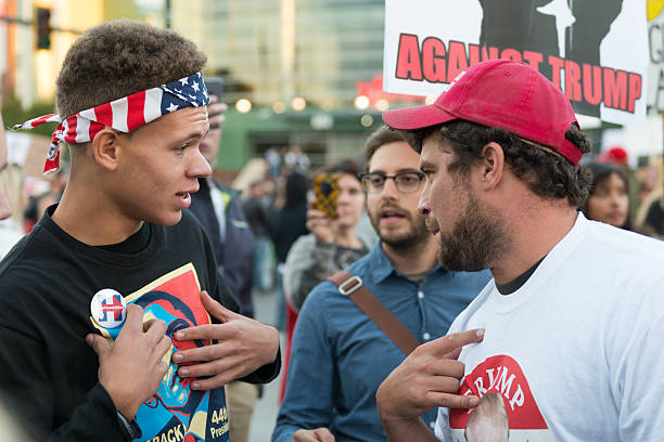 Trump Protest Everett, USA - August 30, 2016: A heated exchange between a Hillary and Trump supporter at the Donald Trump rally outside the Xfinity Arena in Everett late in the day. donald trump stock pictures, royalty-free photos & images