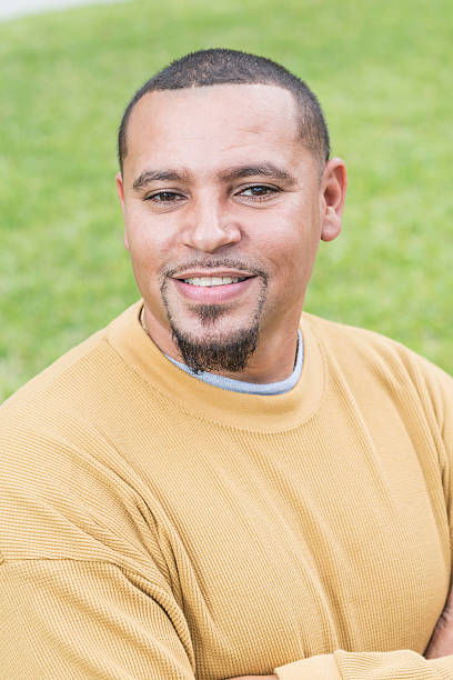 istock Young mixed race man standing, arms folded, outdoors 598077624