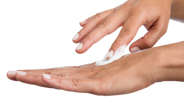 istock Woman Applying Moisturizer Cream 598078572