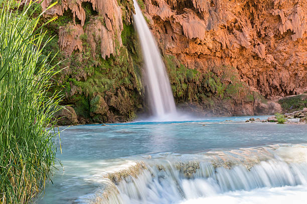 Travertine Ledge below Havasu Falls A travertine ledge below Havasu Falls where it plunges into a deep blue-green pool on the Havasupai Indian Reservation in the Grand Canyon. harasu canyon stock pictures, royalty-free photos & images