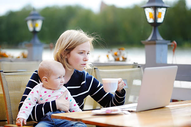 istock Young mother with her baby working or studying on laptop 598078846