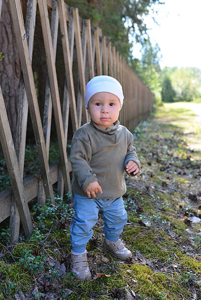 istock beautiful and cute baby boy walking in park 598079708