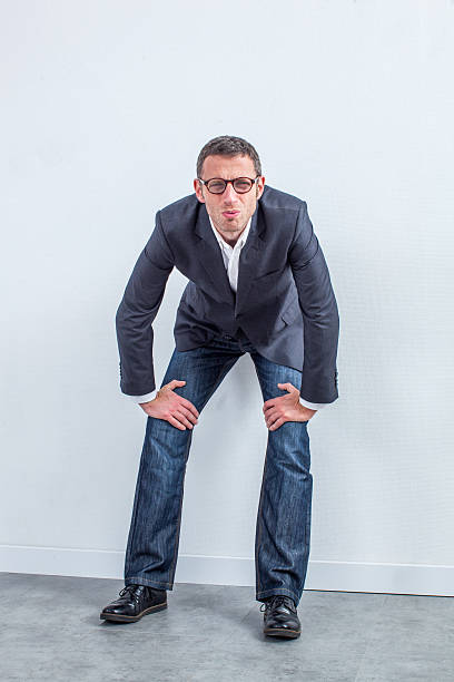 istock staring middle aged businessman with eyeglasses with management issue denial 598080022